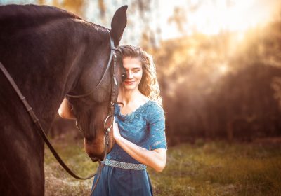 Beautiful girl in a blue dress hugs a horse. Fairytale photography, artistic, magical Beautiful girl in a blue dress hugs a horse. Fairytale photography, artistic, magical